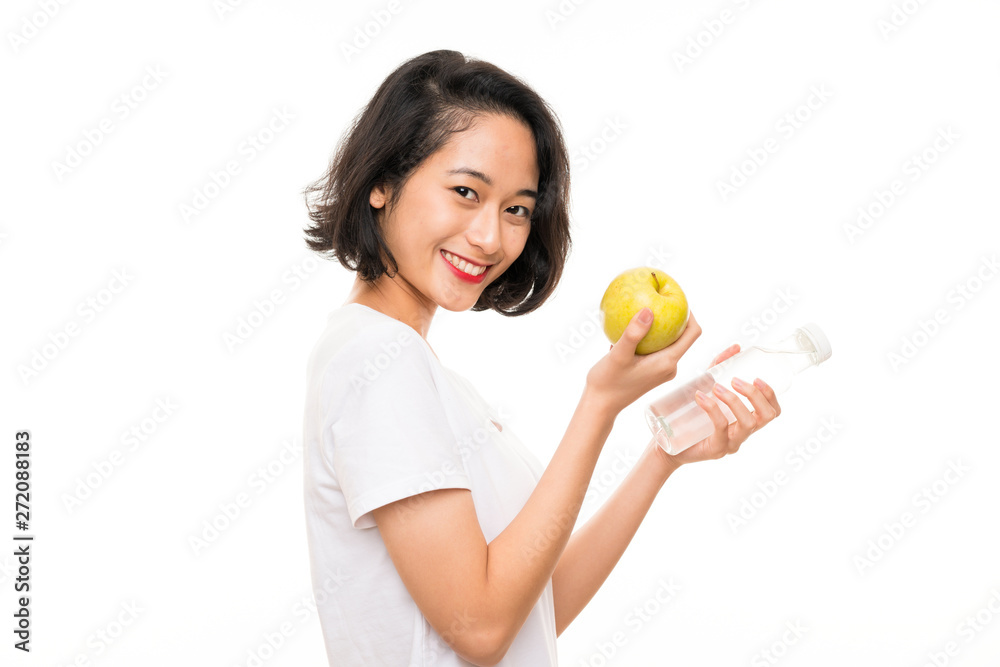 Asian young woman with an apple and bottle of water Asian young woman with an apple and bottle of water