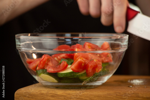 Beautiful, juicy tomato sliced on a wooden table
