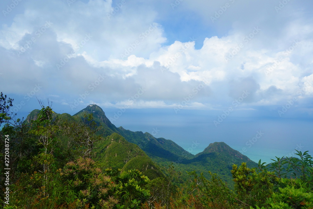 Amazing panorama view from the o Gunung Raya mountain, the highest point in Langkawi, Malaysia. Distant mountains in the mist and the ocean on the background. Tranquility and serenity.