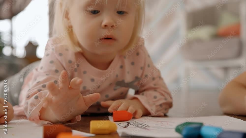 Smiling toddler lying on the floor and playing Smiling toddler lying on the floor and playing
