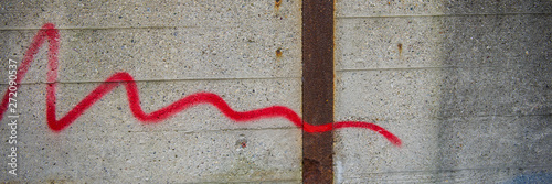 concrete wall with a trace of red paint.