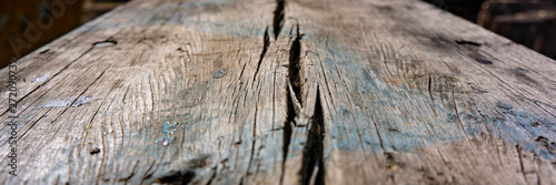 Old wooden cracked board in the open air.