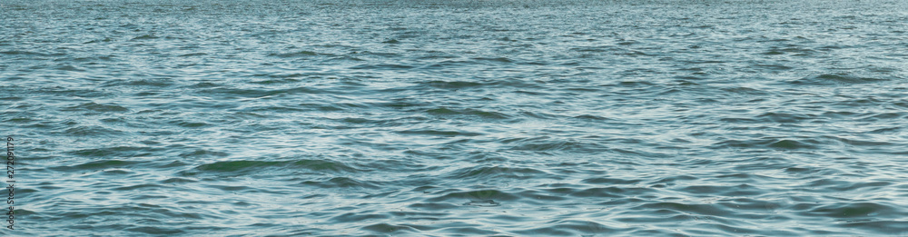 Panoramic widescreen view on the deep blue sea or ocean with dramatic toning. Boundless waving sea. Fascinating and pacifying background. Panoramic widescreen view on the deep blue sea or ocean with dramatic toning. Boundless waving sea. Fascinating and pacifying background.