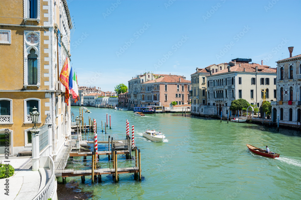 A sunny view of a Grand Canal, near the Venice Santa Lucia Railway Station from top of Scalzi Bridge in Venice, Italy
