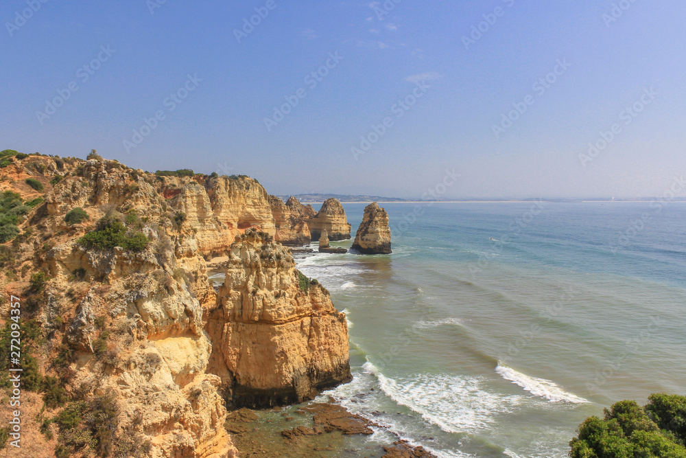 Beautiful golden cliffs and emerald water in Ponta da Piedade, Lagos, Algarve, Portugal