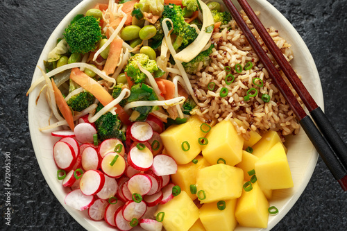 Asian style Vegan salad bowl with edamame, vegetable stir-fry mix, wholegrain rice, quinoa, mango chunks drizzled with mango, chilli dressing