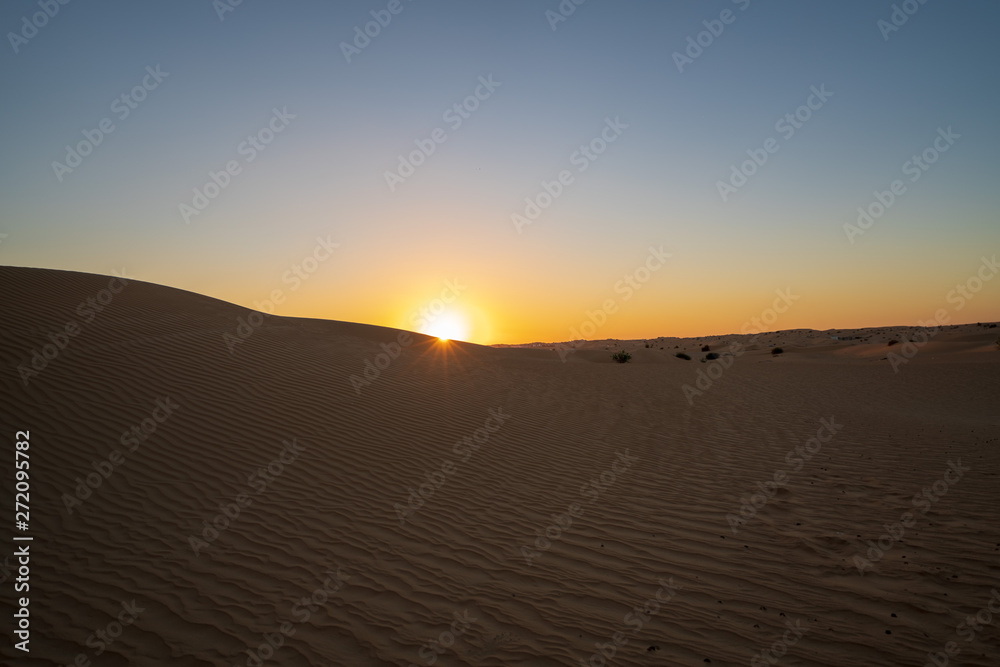 Sunset at dune in Dubai desert scene