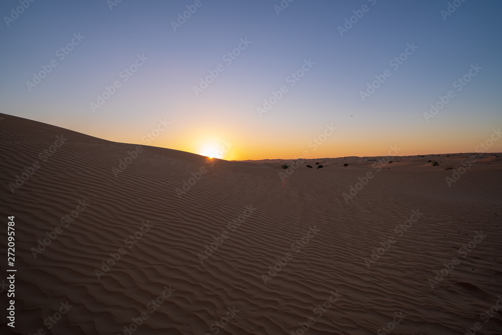 Sunset at dune in Dubai desert scene