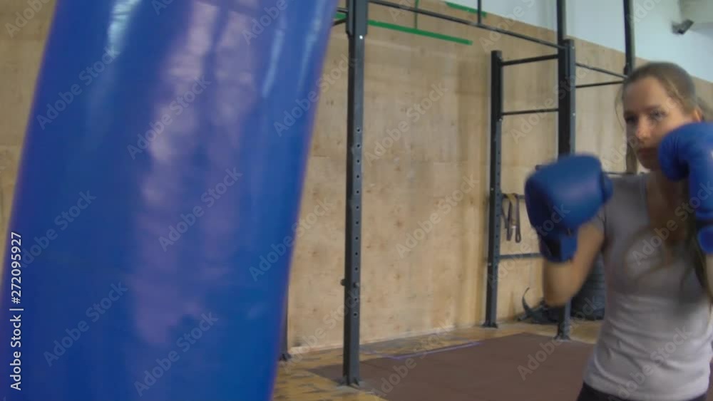 Woman Does Muay Thai Kickboxing Training At The Gym Woman Does Muay Thai Kickboxing Training At The Gym