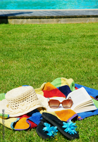 relaxing on the meadow near swimming pool, upright format