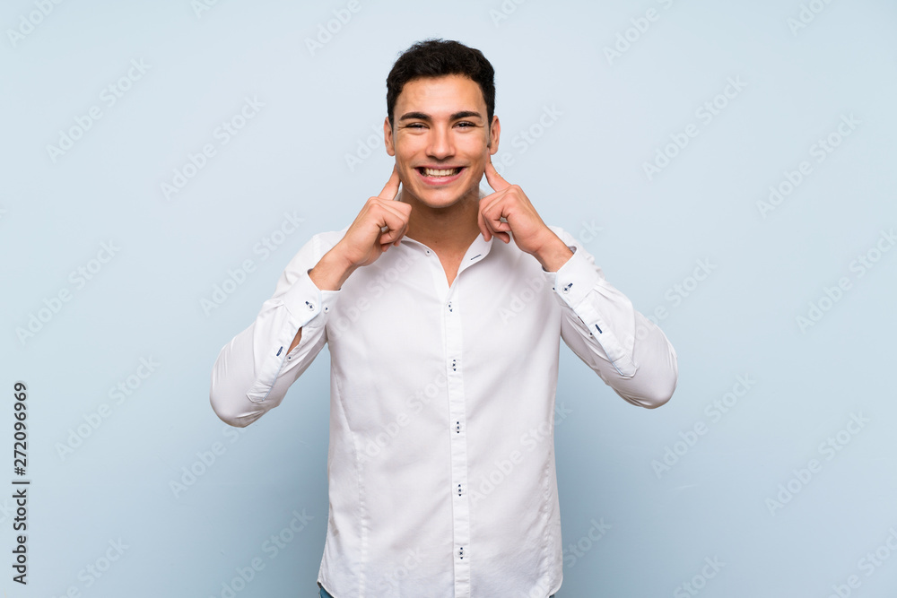 Handsome man over blue wall smiling with a happy and pleasant expression Handsome man over blue wall smiling with a happy and pleasant expression