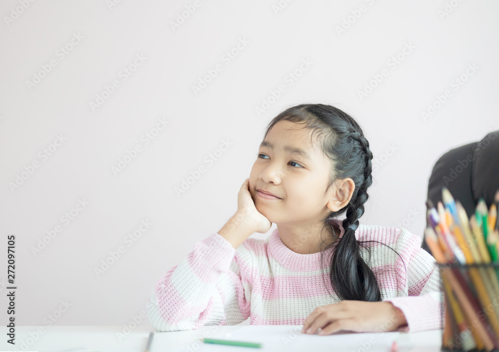 Portrait little Asian girl sitting on the chin and smile with happiness metaphor thinking someting day dreamer concept with copy space select focus shallow depth of field Portrait little Asian girl sitting on the chin and smile with happiness metaphor thinking someting day dreamer concept with copy space select focus shallow depth of field