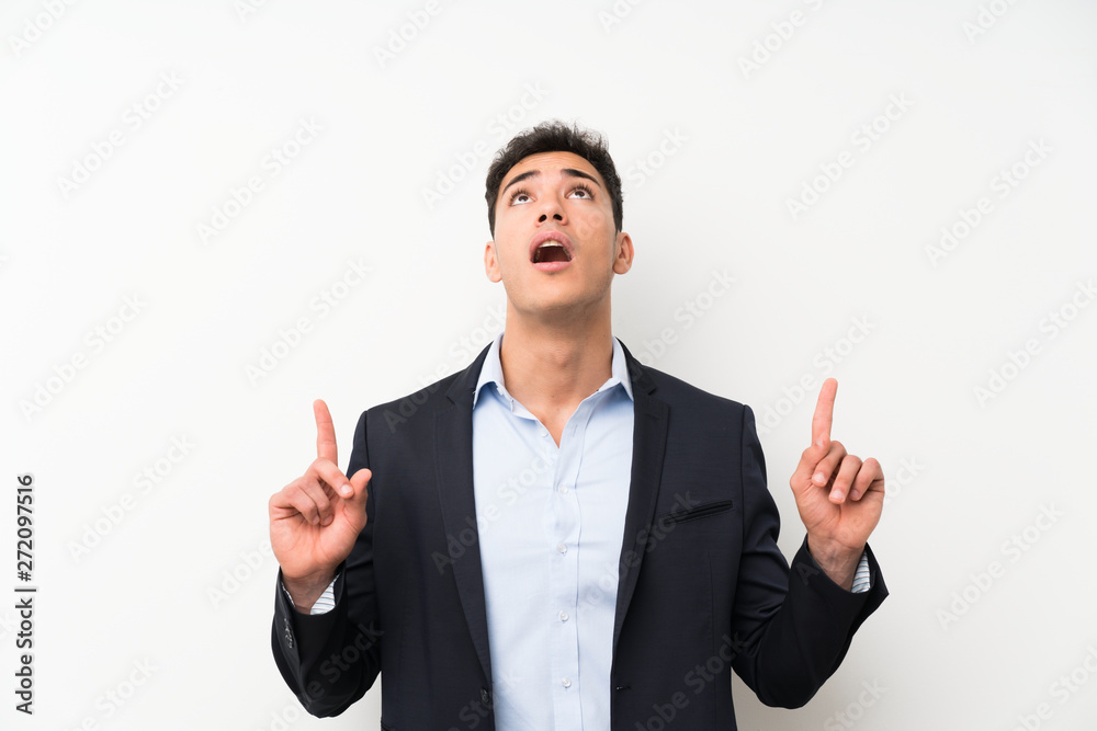 Handsome man over isolated white wall pointing with the index finger a great idea Handsome man over isolated white wall pointing with the index finger a great idea