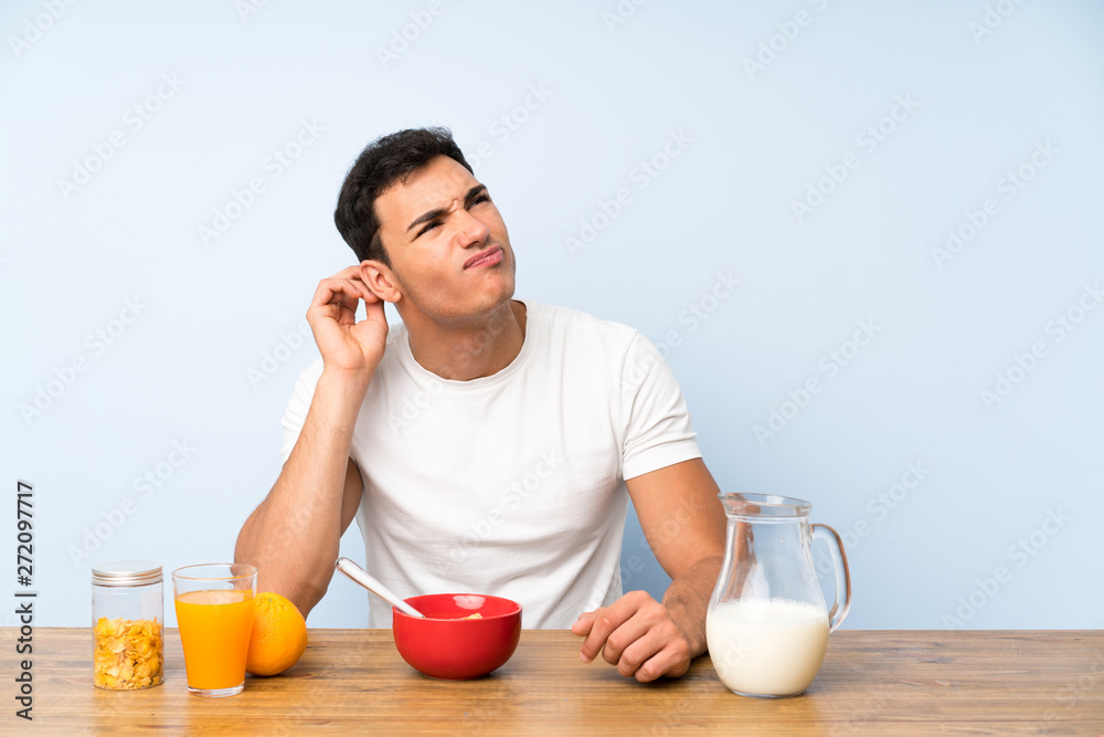 Handsome man in having breakfast having doubts and with confuse face expression Handsome man in having breakfast having doubts and with confuse face expression