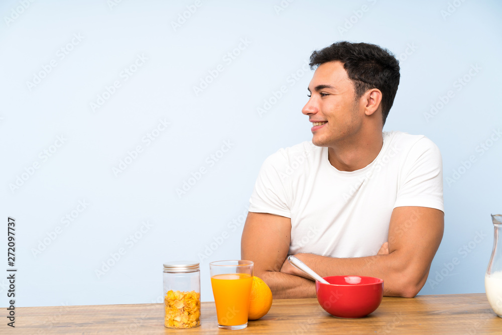 Handsome man in having breakfast looking to the side Handsome man in having breakfast looking to the side