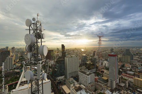 Telecommunication tower with 5G cellular network antenna on city background