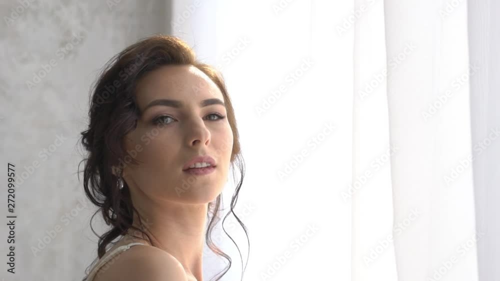 Girl In A Light White Luxurious Wedding Dress Poses, Stands Alone In A Spacious Girl In A Light White Luxurious Wedding Dress Poses, Stands Alone In A Spacious