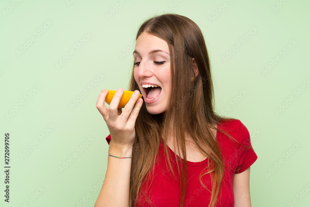 Young woman with long hair holding a grapefruit Young woman with long hair holding a grapefruit