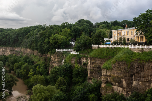 Canyon of the Smotrych River in Kamianets-Podilskyi, covered with green forest, after rain. The river is visible below. Ukraine.
