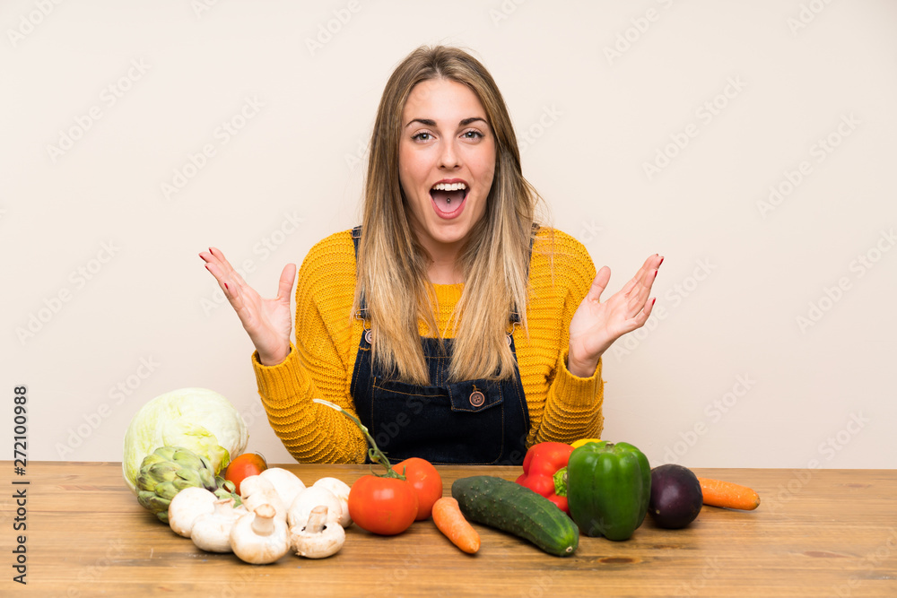 Fototapeta premium Woman with lots of vegetables with surprise facial expression