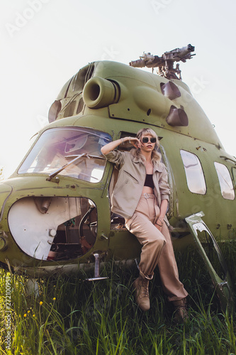 Female pilot in cockpit of helicopter before take off. Young woman helicopter pilot. photo