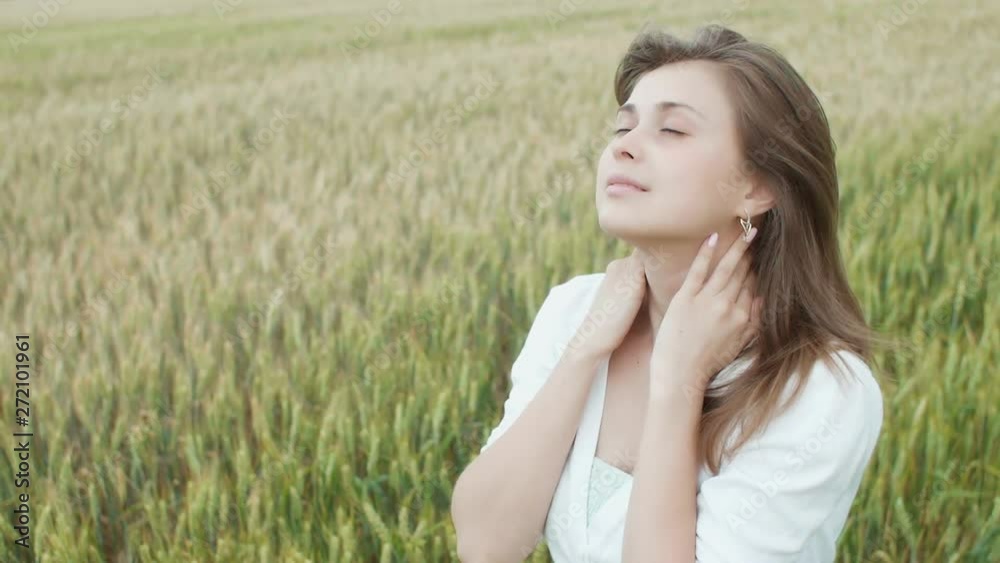 beautiful girl walking and enjoying nature in a field of cereal ears, a young woman rests emotionally and physically, relax beautiful girl walking and enjoying nature in a field of cereal ears, a young woman rests emotionally and physically, relax