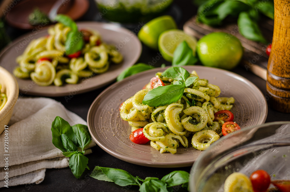 Homemade pasta with fresh basil pesto and tomatoes Homemade pasta with fresh basil pesto and tomatoes