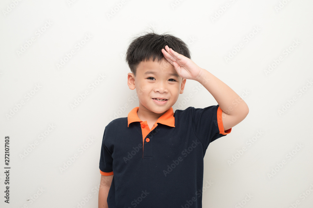 Cheerful little boy putting a hand on the forehead greeting, isolated on a white background. Cheerful little boy putting a hand on the forehead greeting, isolated on a white background.