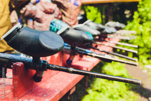 Paintball guns on a wooden table. play paintball. photo