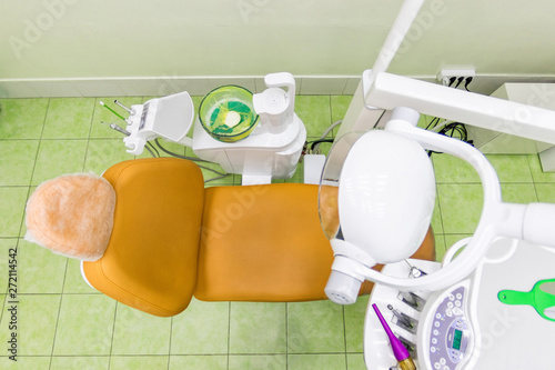 Medical interior, dental office with an orange chair, lamp and equipment. stomatology concept top view