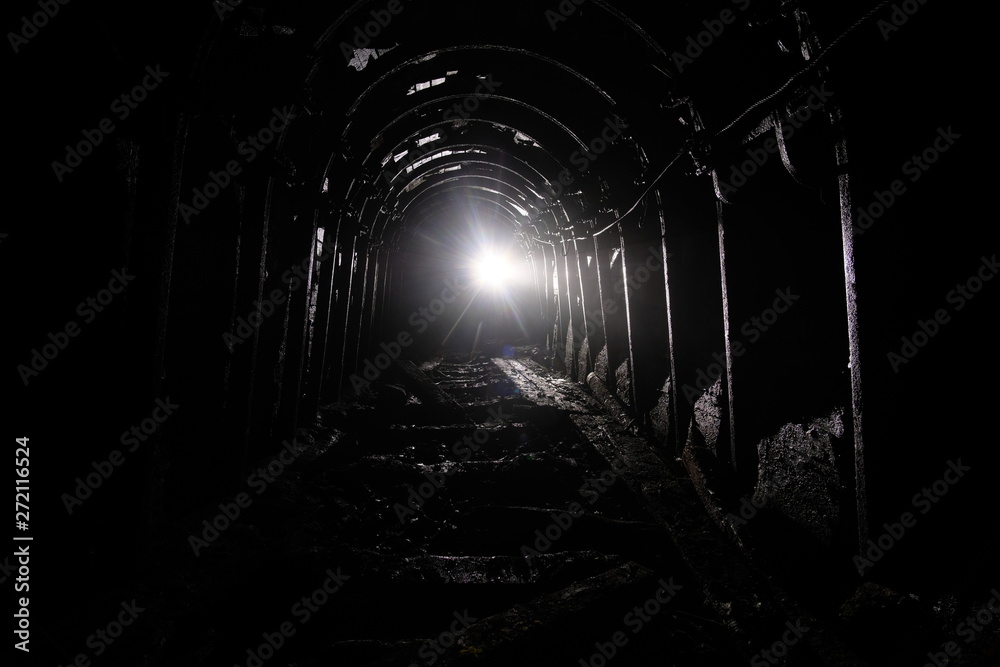 Dark abandoned coal mine with rusty lining in backlight Dark abandoned coal mine with rusty lining in backlight