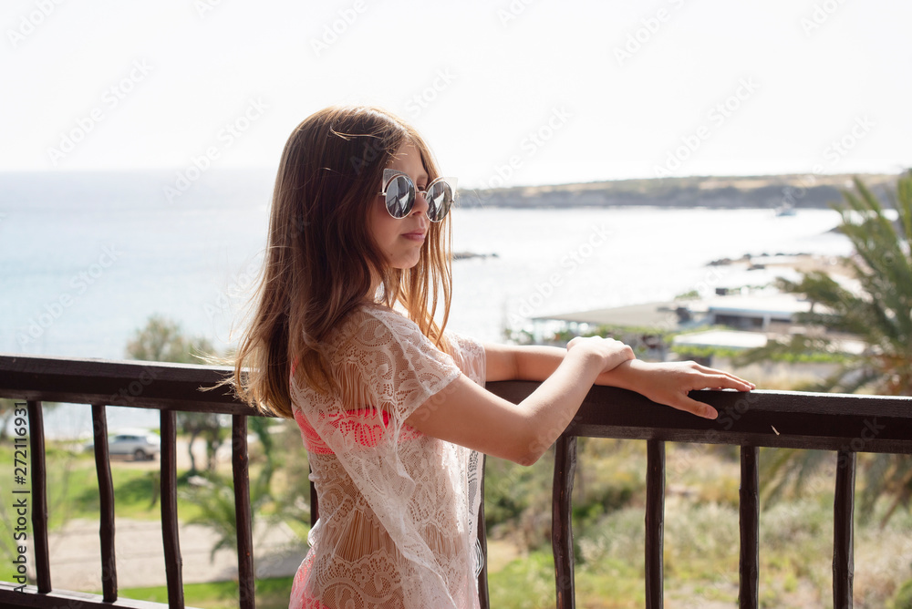 teenage girl in a swimsuit on the balcony teenage girl in a swimsuit on the balcony