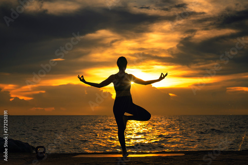Abstrac.Silhouette yoga.Portrait of young woman practicing yoga at the sea.Relax at the sea.Meditation