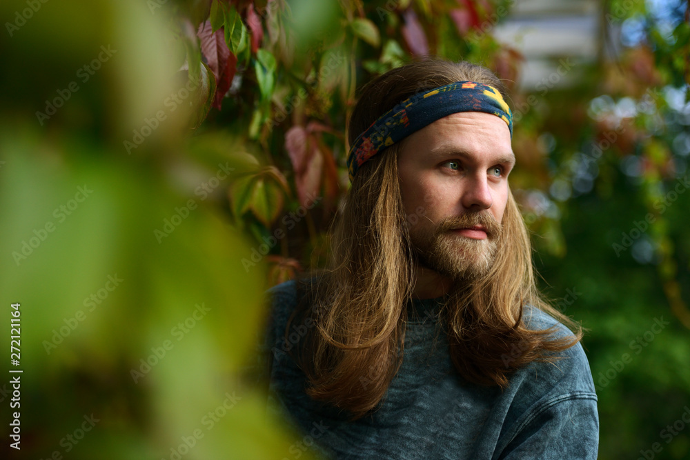portrait of a young man with long hair and beard in a bandana Stock Photo |  Adobe Stock