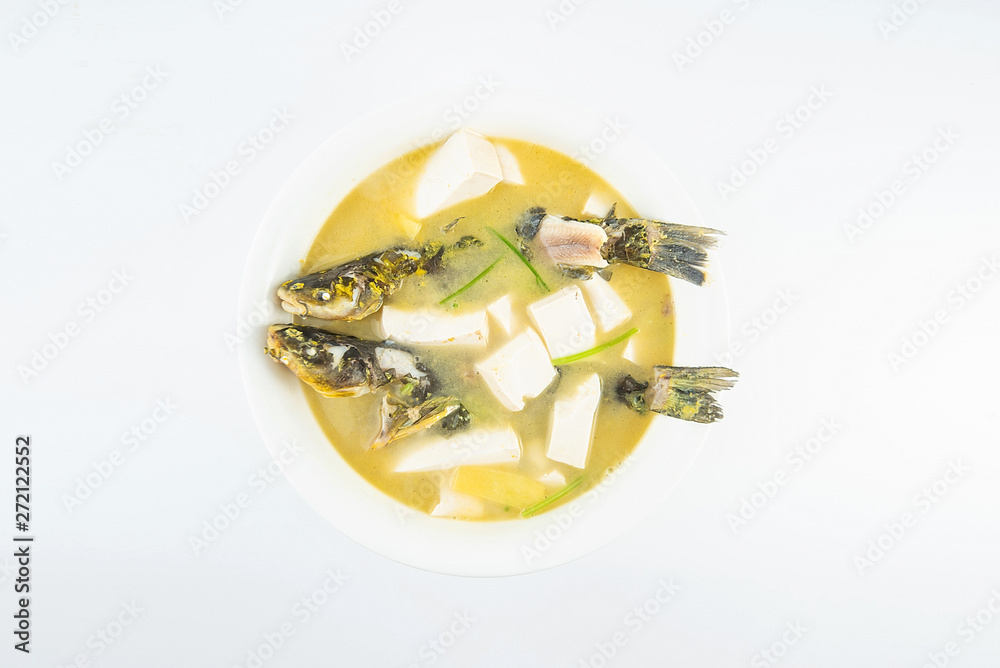 Chinese gourmet fish soup, a large bowl of yellow bone fish tofu soup on a white background