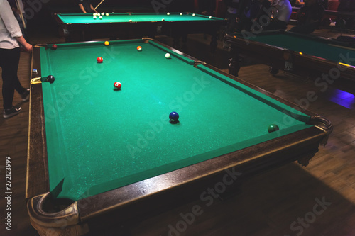 large vintage pool tables in the night bar, retro toned