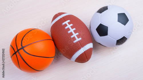 Balls for american football, basketball, soccer. lie on the green. Outdoor sports championship. Different types of games. copy space