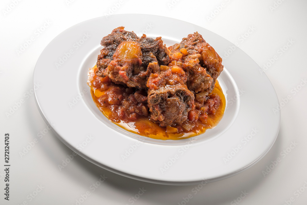 Isolated Dish with a portion of oxtail stewed vaccinara