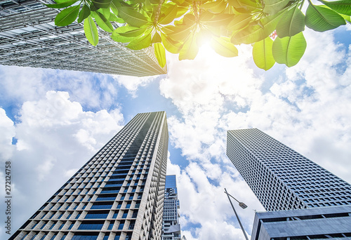 Looking up at the city CBD building glass curtain wall and blue sky and white clouds