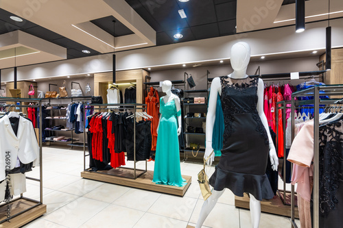 Internal view of a fashion store with generic jackets, mannequins, jeans and clothes.