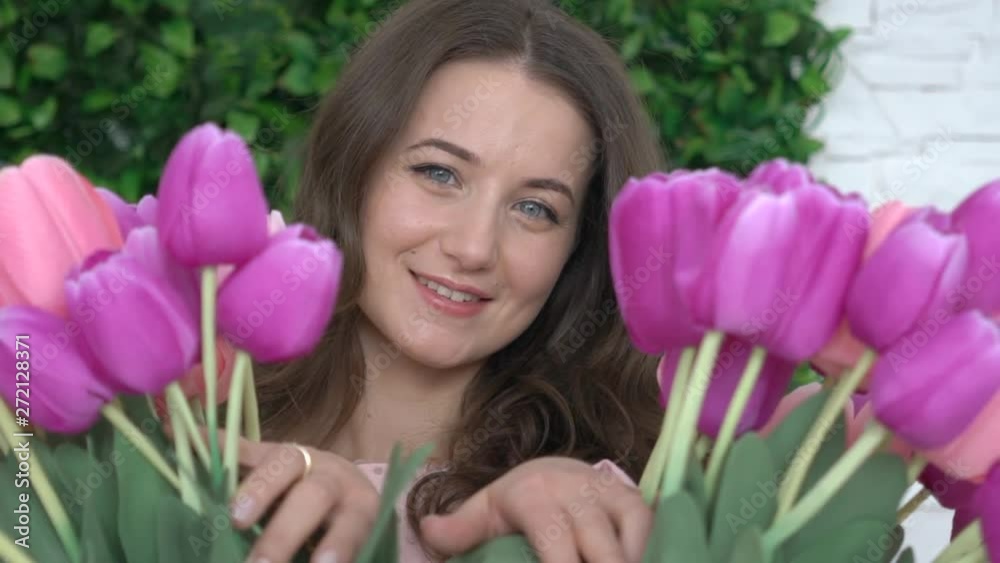 Attractive Young Woman Looking Behind Tulips Attractive Young Woman Looking Behind Tulips
