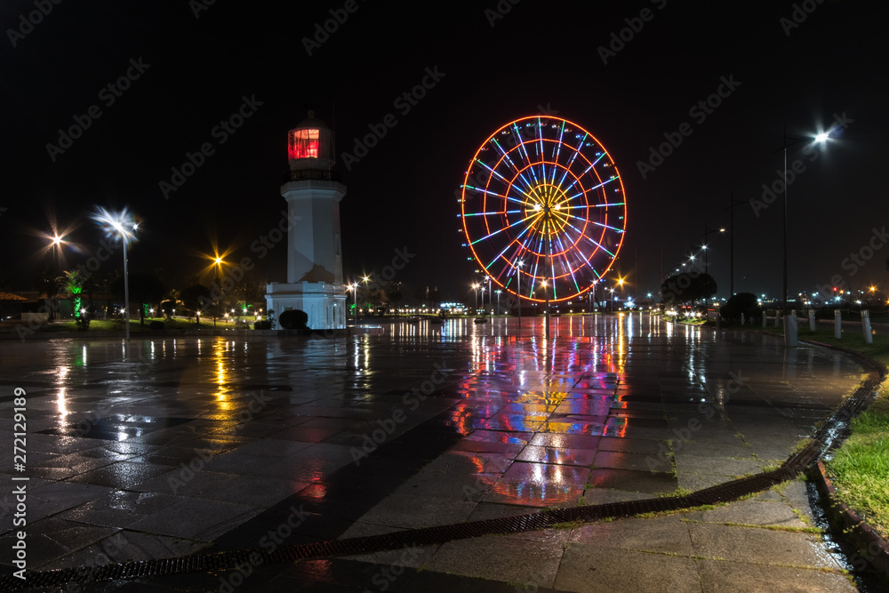 Ferris wheel and lighthouse on the embankment of Batumi