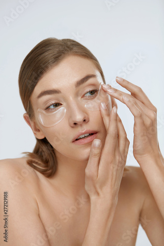 Tela Eye skin care. Woman applying beauty patch mask under eyes