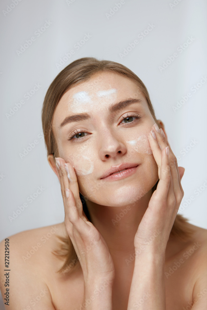 Face skin care. Woman cleaning facial skin with foam soap