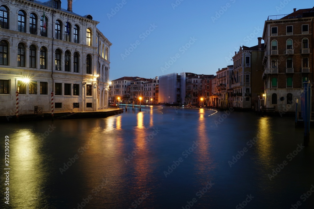 Dawn view over Grand Canal and first boats passing by
