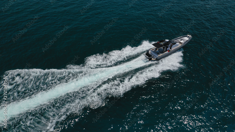Aerial top view luxury inflatable rib speed boat cruising in Aegean deep blue open sea Aerial top view luxury inflatable rib speed boat cruising in Aegean deep blue open sea