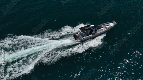 Aerial top view luxury inflatable rib speed boat cruising in Aegean deep blue open sea