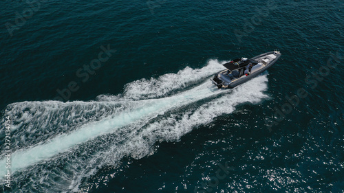 Aerial top view luxury inflatable rib speed boat cruising in Aegean deep blue open sea © aerial-drone