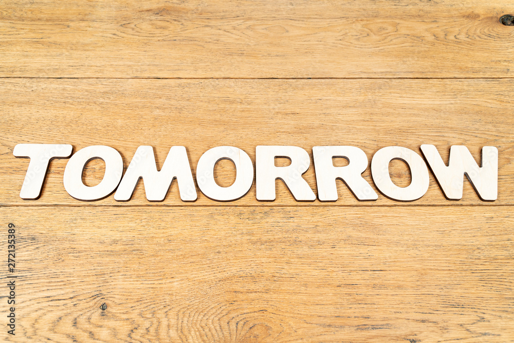 Word tomorrow on a wooden table
