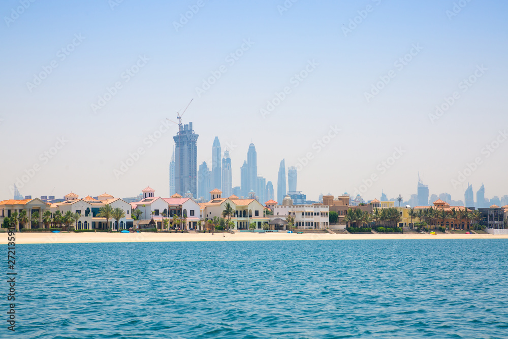Dubai Marina skyscrapers and villas on the Palm Jumeirah. Luxury properties of UAE
